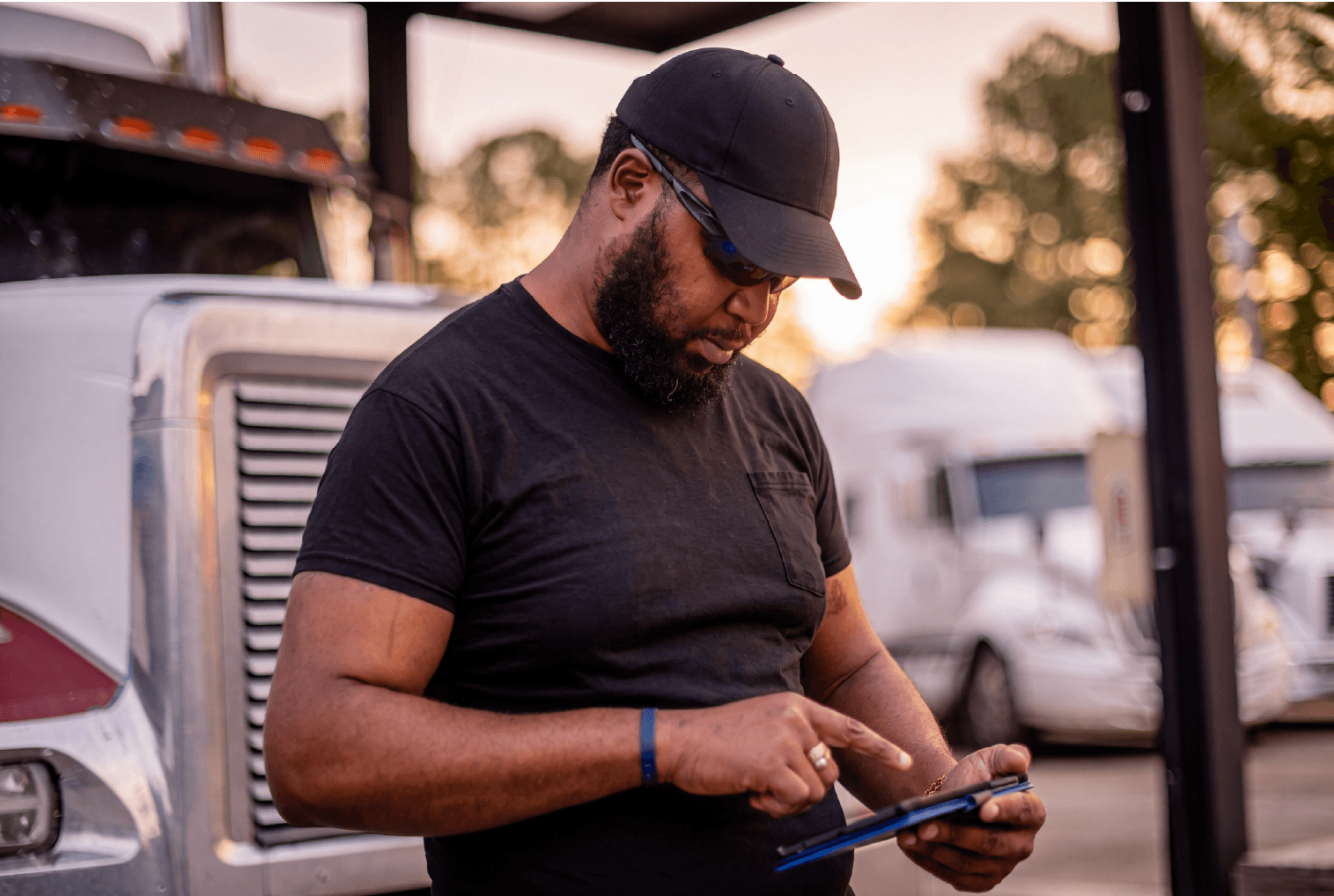 man outside of truck using device for shipments