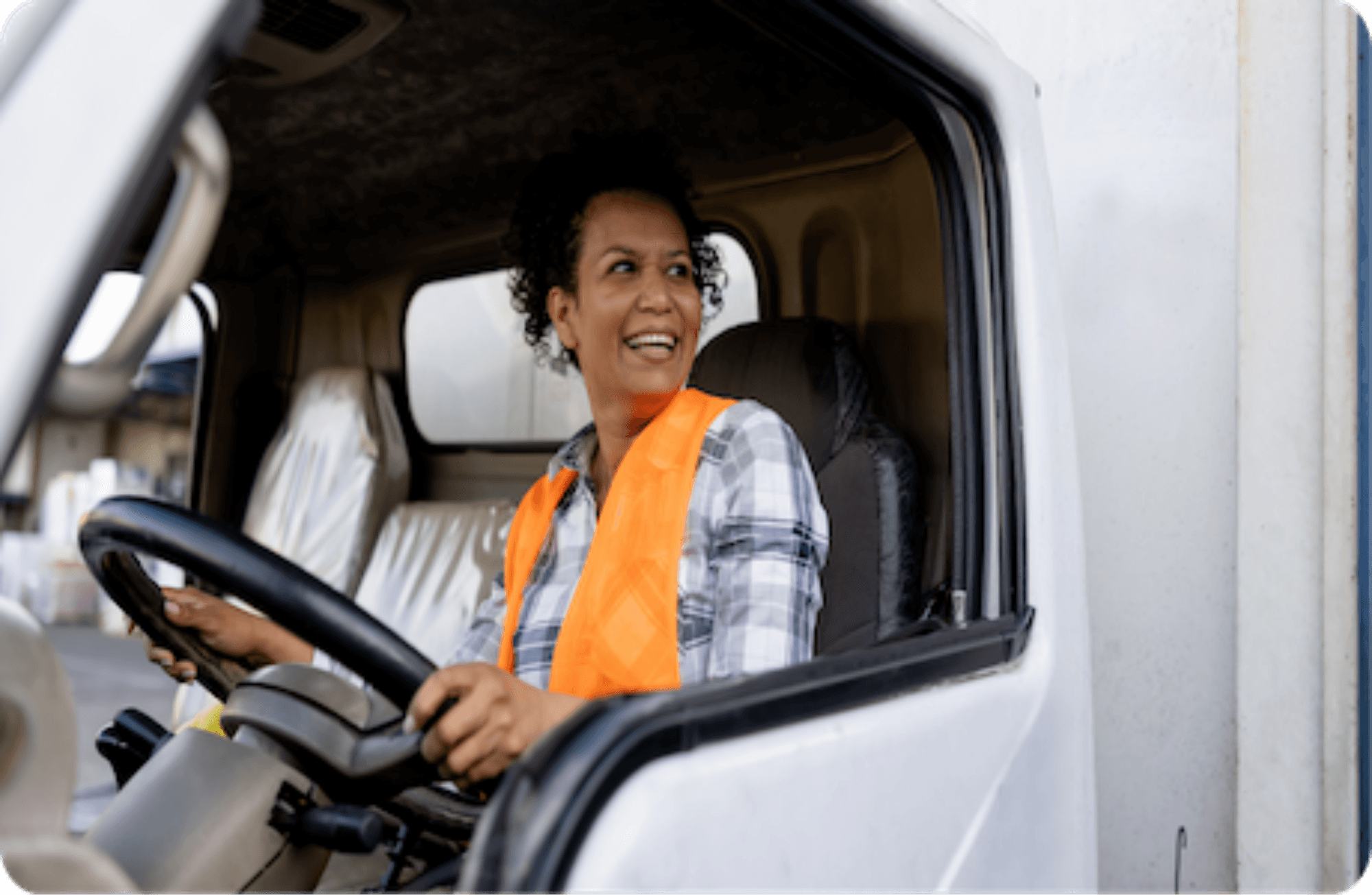 lady in safety vest driving truck