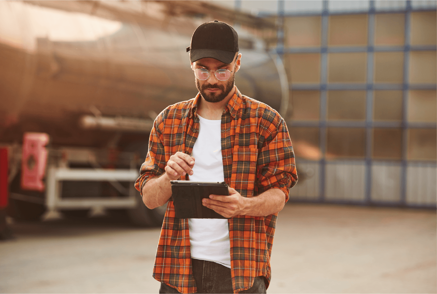 Man outside of truck using device to track shipments