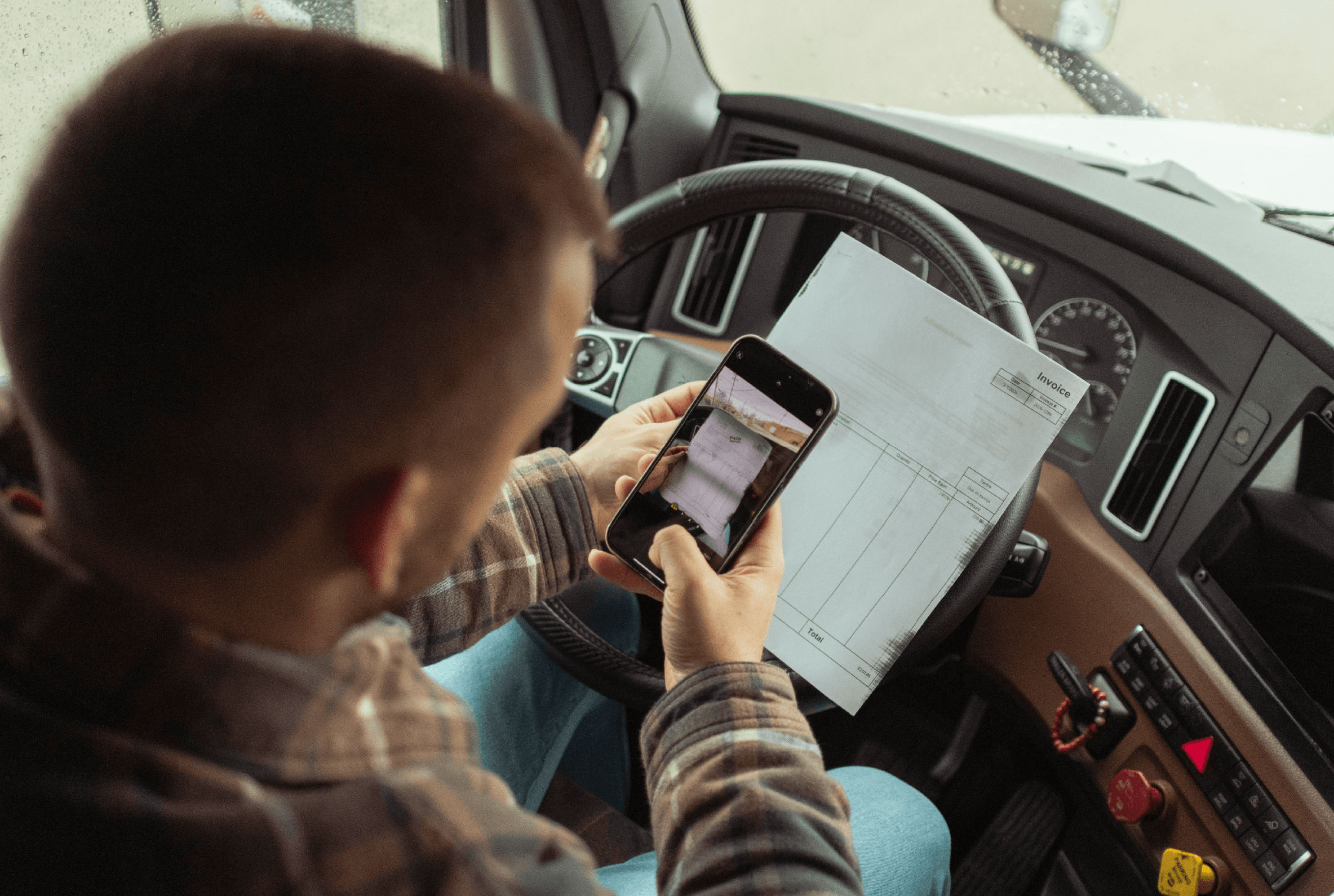 Man taking a picture using his cell phone to take a picture of an invoice