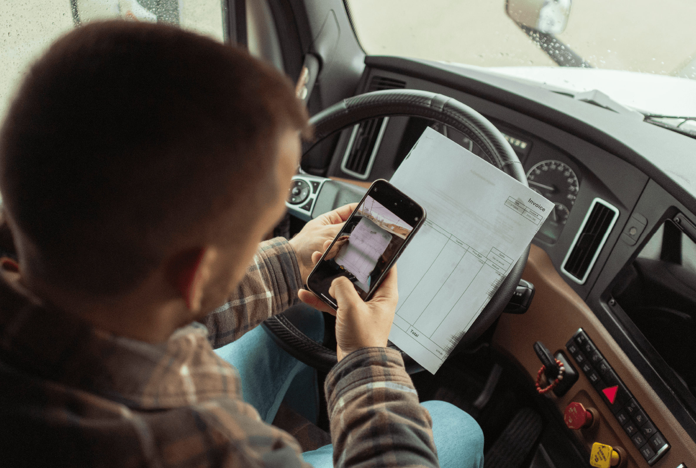 Man taking a picture using his cell phone to take a picture of an invoice