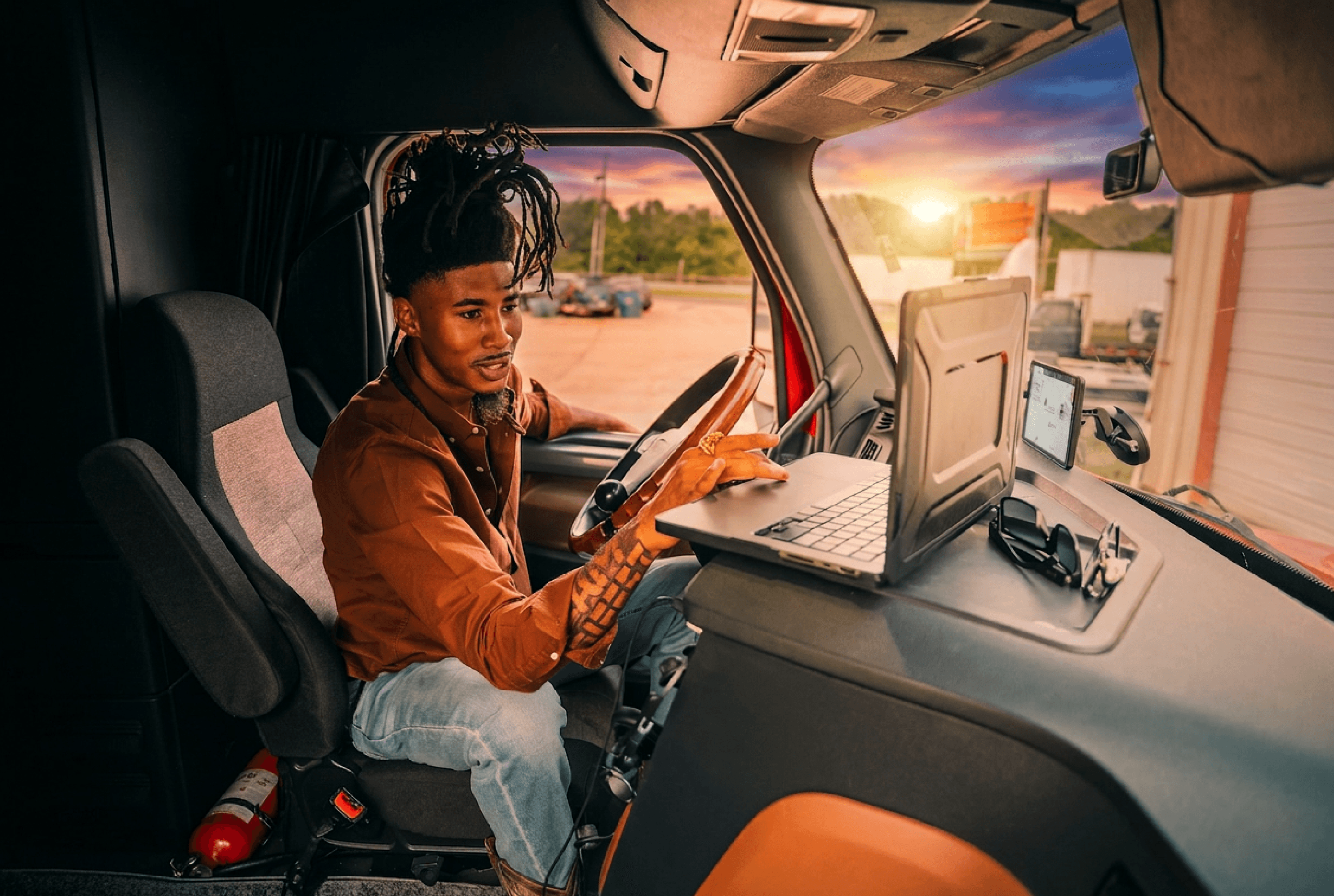 Man inside of truck checking a laptop